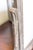 An Art Deco tilting photo frame in painted wood with a distressed silver-gray finish, the warm rose-toned underlayer worn...