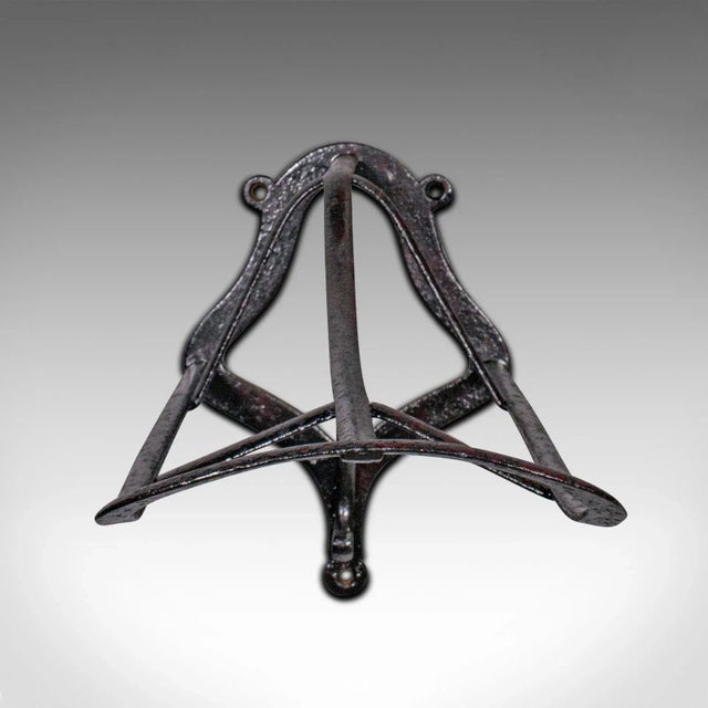 This is an antique 'duck bill' saddle rack. An English, cast iron wall mounted equestrian tack rest, dating to the early...