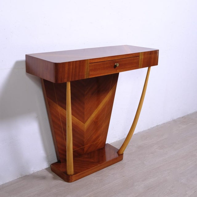 Elegant and particular wooden console, design and production of the 1950s, the style is very reminiscent of that of Paolo...
