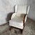 A striking Art Deco oak rocking armchair with sweeping timber lines and a generous upholstered form. The continuous curved...