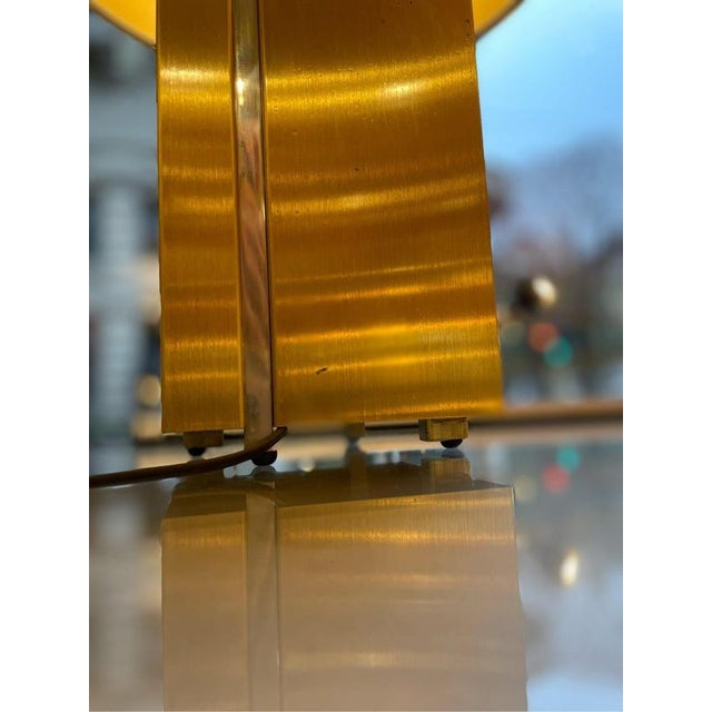 Pair of brass and steel table lamps with a square base. The lamps are from the 1970s, with an original black lampshade in...