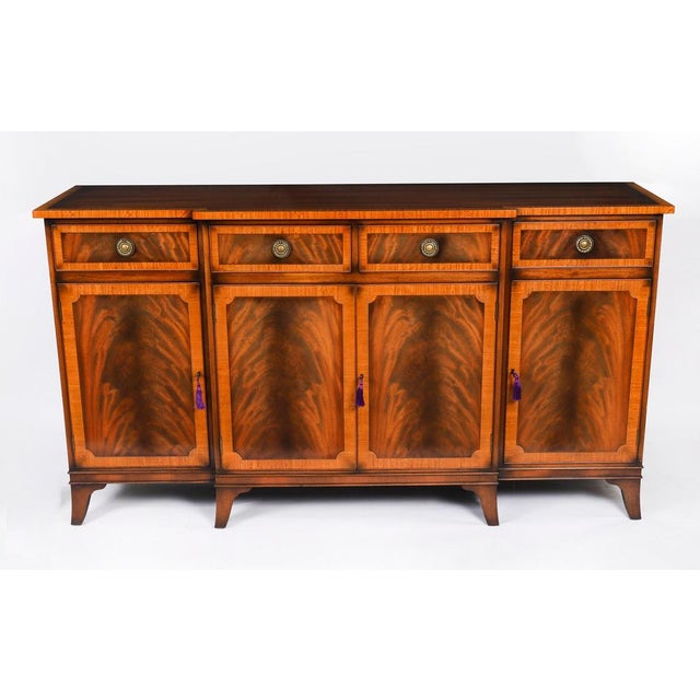 This is a fabulous Vintage pair of Regency Revival flame mahogany breakfront sideboards, bought at great expense from...