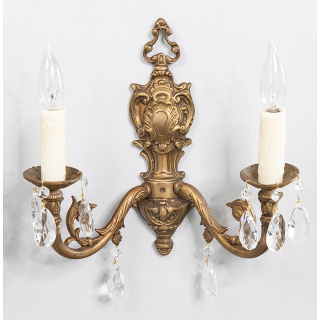 Classic French gilt bronze wall sconces, having lovely faceted crystals. Newly rewired and ready to hang.