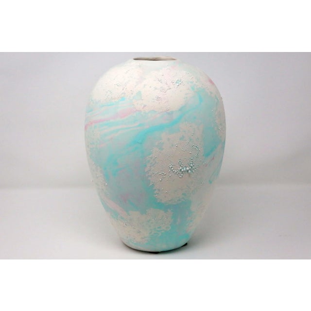 A vintage, large ceramic vase, with white, pink and turquoise swirled glaze, and an interesting, textured finish. Good...