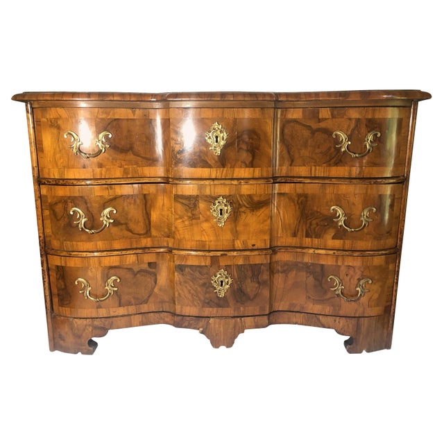 Mid-18th century high gloss Rococo walnut serpentine front, gilt bronze mounted three-drawer chest with bracket feet,...