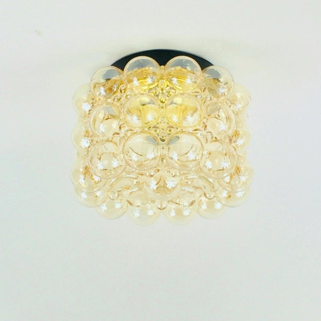 Stunning mid-century modern amber bubble glass ceiling mount fixture designed by Helena Tynell for Limburg, Germany's...