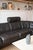 A Swiss black leather modular sofa in the style of De Sede. Two end sections, a corner and three side sections (two with...