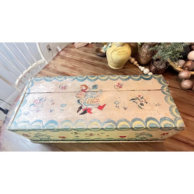 This is a vintage hand-painted wooden folk art lift-top box or small blanket chest, appearing to be in the mid-20th-...