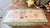 This is a vintage hand-painted wooden folk art lift-top box or small blanket chest, appearing to be in the mid-20th-...