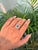 This halo engagement ring features a 0.92-carat natural emerald set in 14K white gold. The center emerald measures...