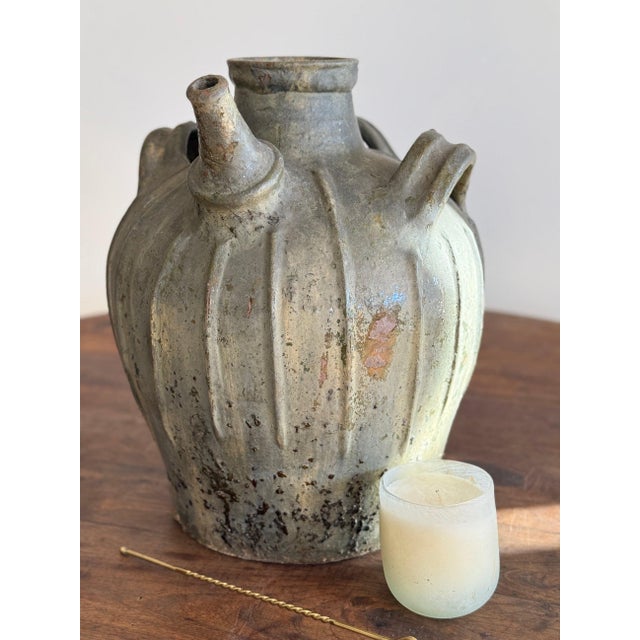 This rare 18th century walnut oil jug is a quietly striking example of early utilitarian pottery, shaped by hand and...