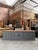 This handcrafted sideboard features a grey-patinated body and a natural wood top. It comprises eight practical drawers...