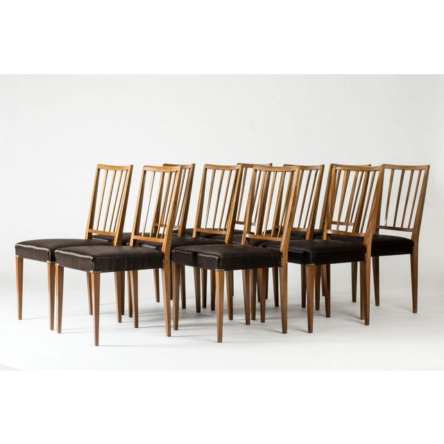 Set of ten dining chairs by Josef Frank, model #815, made from mahogany. Elegant, ribbed backs. Decor of brass nails...