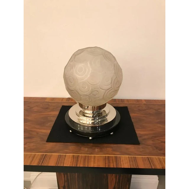 Rare French Art Deco table lamp created by "Marius Ernest Sabino" (1878-1961). The glass shade is frosted glass with...