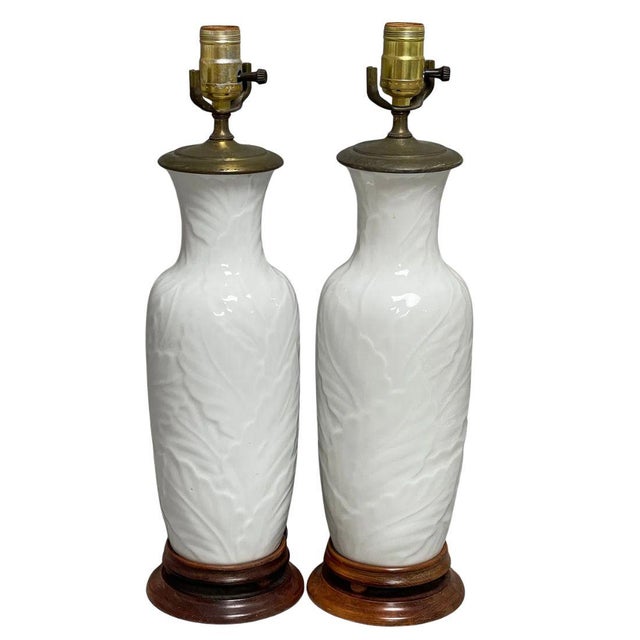 A graceful pair of table lamps crafted from white porcelain, featuring an all-over palm leaf relief design that adds...