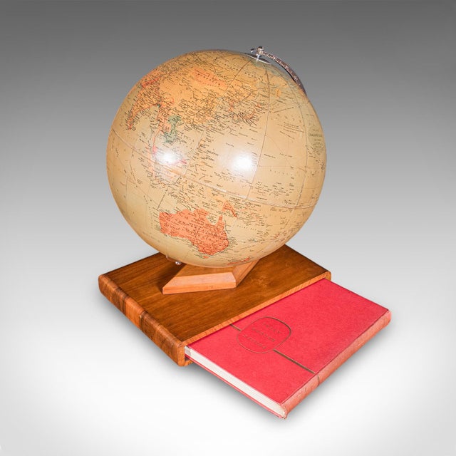 This is a vintage table globe and atlas set. An English, paper finished world map with chrome meridian and hardback...