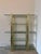Beautiful vintage brass and glass shelving unit with a sculptural, architectural frame and substantial glass shelves with...