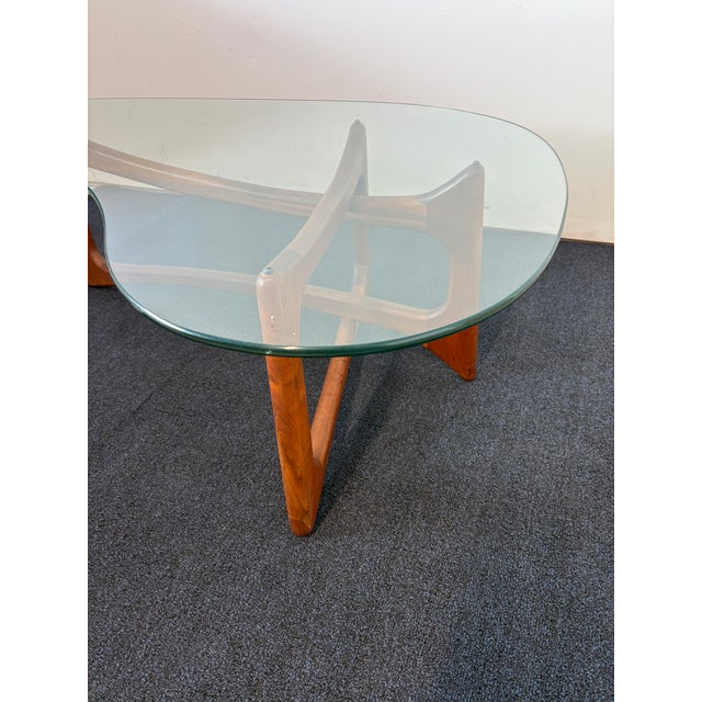 Attributed to Adrian Pearsall amoeba / freeform glass coffee table featuring a sculptural solid walnut base and thick...