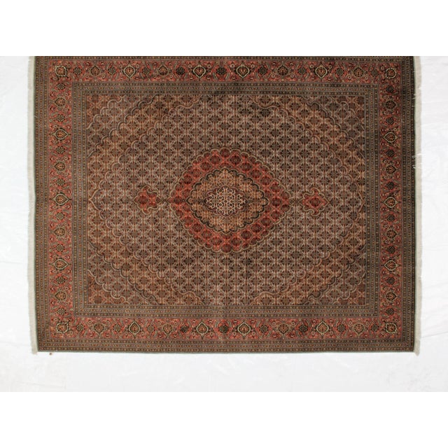 This masterpiece is a silk and wool pile genuine hand woven very fine Persian Mahi Tabriz. The piece is in mint condition.