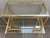 Beautiful rolling cabinet with a square, gold-tone tubular metal frame and three glass shelves. The middle shelf slides...