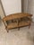 This piece of furniture is a vintage demilune (half-moon) console table crafted from rattan and cork. Its design,...