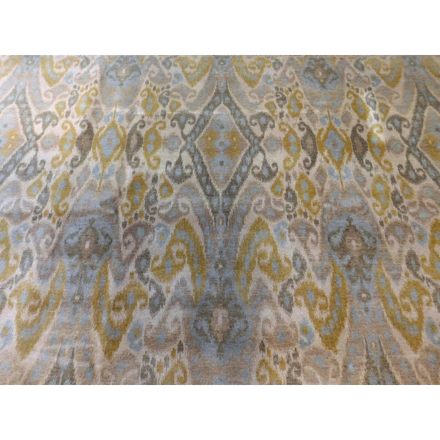 Allover Ikat design with diamond pattern on ivory field. Hand knotted with 100% pure wool pile, in soft color palette on...