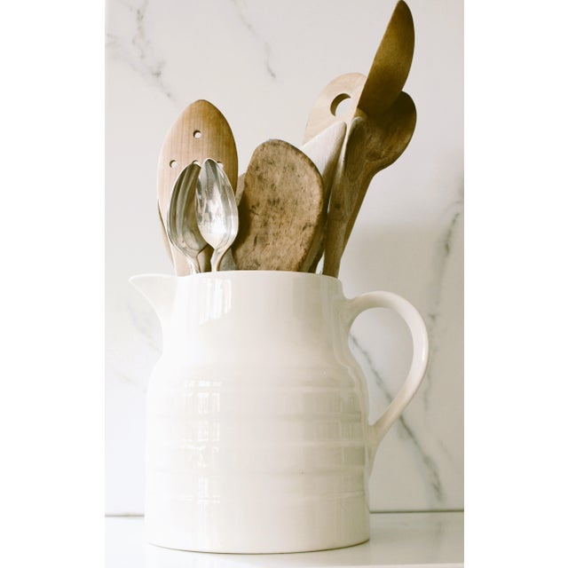 Early 20th Century English ironstone pitcher. We love it's pretty raised banding design giving it much character...