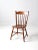 A mid-20th-century Tell City dining chair featuring a sleek, modern Windsor-style silhouette with a classic spindle back...