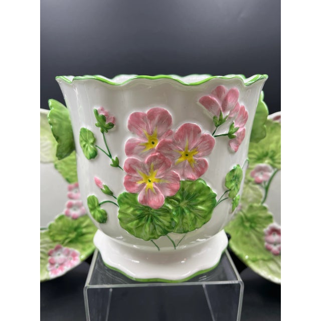 Floral Cachepot/Jardiniere and six (6) matching plates. Hand painted pink geranium design with bright green leaves. The...