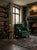 A sophisticated Hungarian Art Deco lounge armchair featuring rich green velvet upholstery, a gently tufted backrest, and...