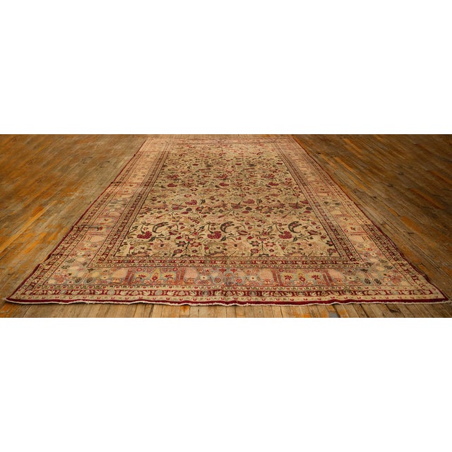 This antique Mashad rug from Iran's Khorasan province features a classic design with a central medallion, intricate floral...