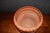 Japanese terracotta jardinère in a warm reddish-orange finish, featuring applied relief decoration of dragons, birds, and...