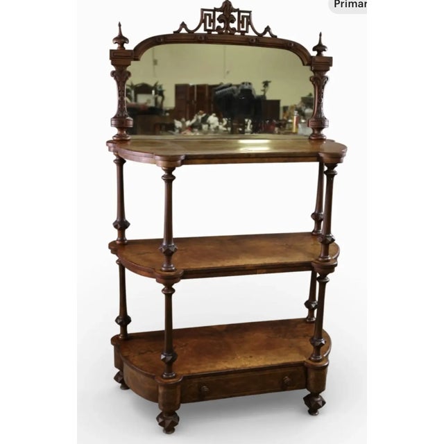 Beautiful antique Victorian inlay etagere, featuring a serpentine shape, three tiers, an oval mirror top with lower...