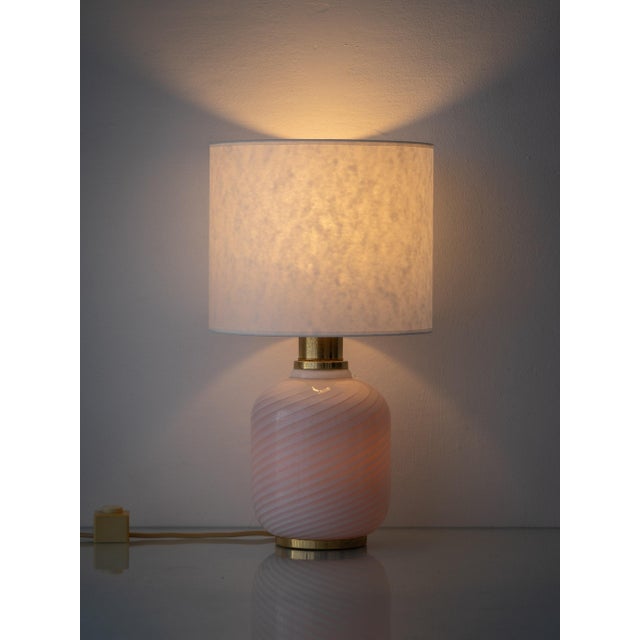 A pair of hand-blown Murano glass lamps in milk-white opaline combining refined Venetian craftsmanship with a rare and...