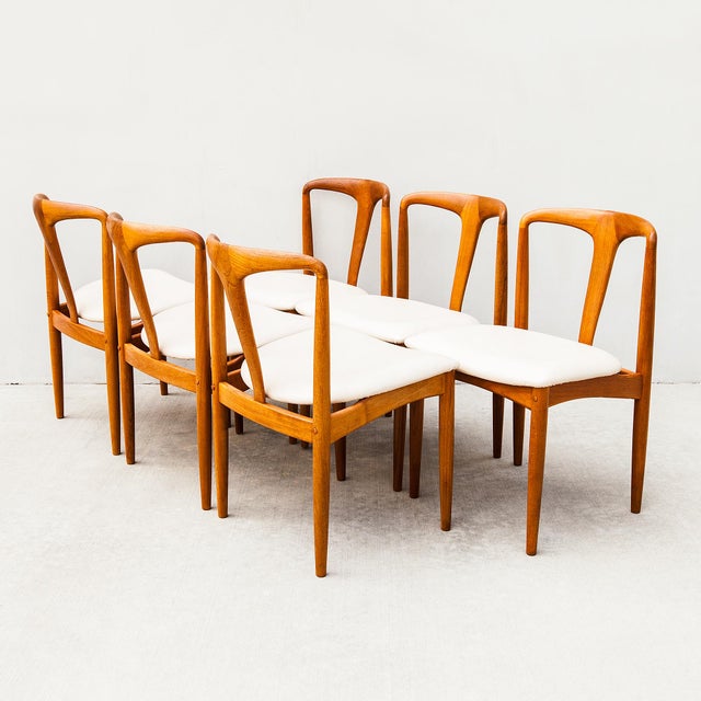 A newly restored set of six iconic "Juliane" dining chairs in solid teak and Edelman leather, designed by Johannes...