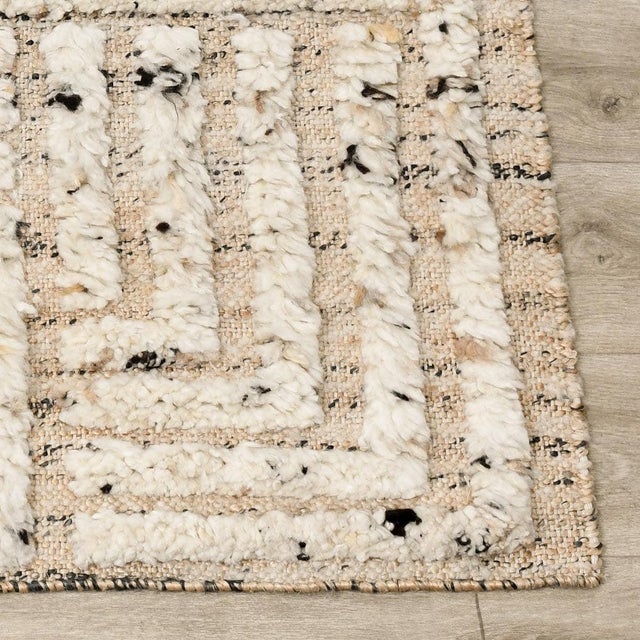 Jute backed rug with soft high piled wool in a striking linear geometric design. Flecks of black add an organic, almost...