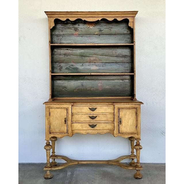 This exquisite hand-painted hutch by the renowned Casa Gusto is a masterclass in whimsical sophistication and old-world...