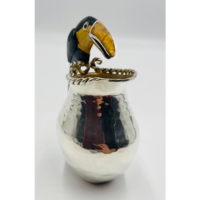 A charming and highly collectible silver-plated creamer pitcher designed and handcrafted in Taxco, Mexico by renowned...