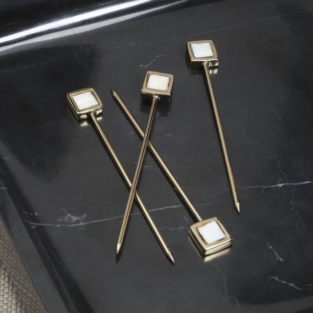 A sophisticated addition to any barware collection, this set of four cocktail picks is crafted from polished brass and...