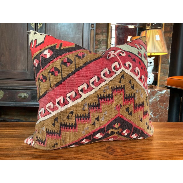 This custom pillow is made from a fragment of an antique, handwoven Kilim rug. The design features a rich geometric...