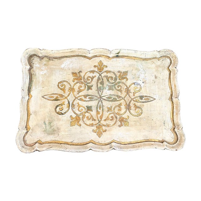 This side table is sturdy yet light. The frame is painted gold, and the top is covered in beautiful Florentine ornamentation.