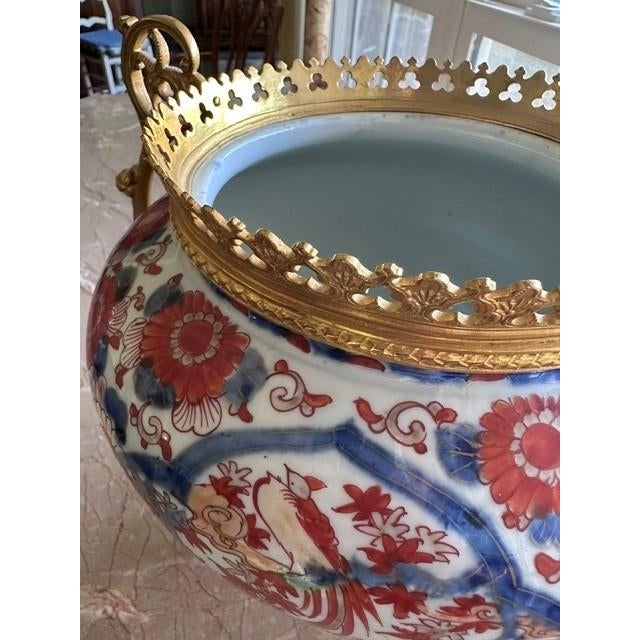 This is a 19th century Japanese Imari porcelain vessel featuring traditional hand-painted floral and bird motifs in the...