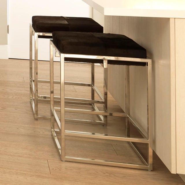 A soft hide seat and a sleek, architectural metal frame come together in the art-deco inspired stool. Featuring hand-...