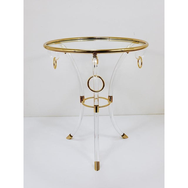 This French round coffee table / side table from the 1970s captures the essence of the Hollywood Regency era. Crafted from...