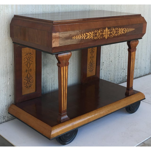 About Early 19th century console in rosewood and maple. It features beautiful marquetry of rinceaux and floral motifs. It...