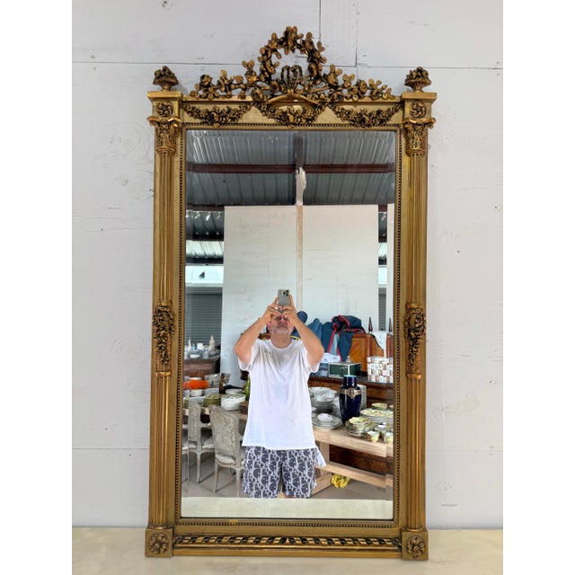 Exceptional large 19th century French Louis XVI carved and giltwood mirror. Featuring intricately carved flowers,...