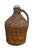 Antique clear glass wine bottle / demijohn / carboy / jug wrapped in woven wicker with twisted handle. No stopper or cork....