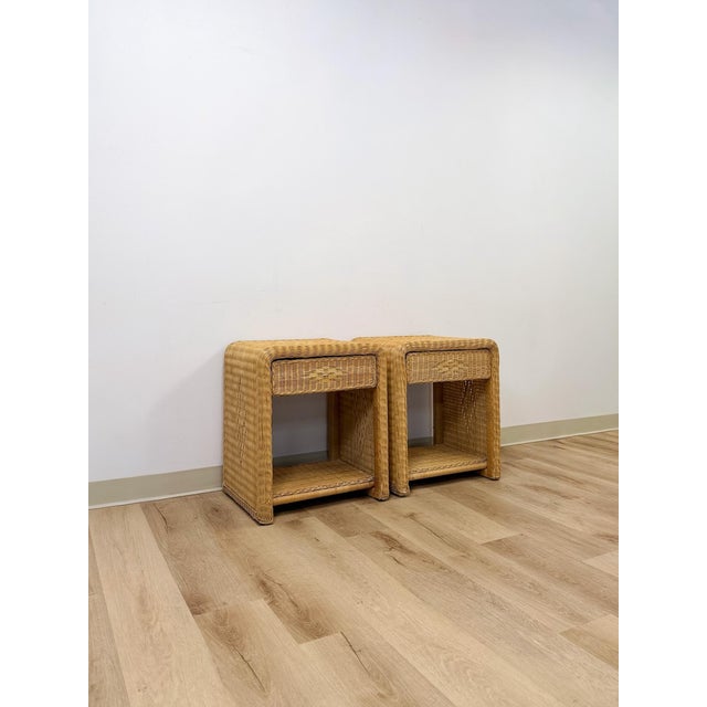 This pair of vintage wicker nightstands showcases a graceful arched silhouette, offering a softer, more sculptural...