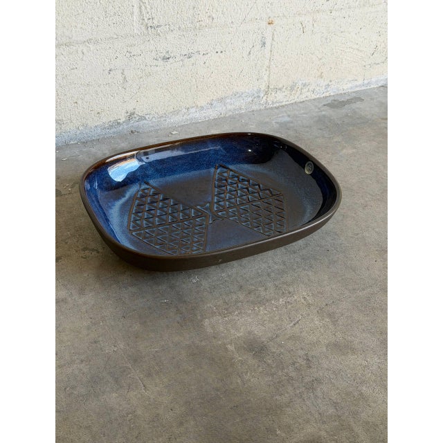 This vintage ceramic serving platter features a striking organic shape with an elegant recessed center. The interior...