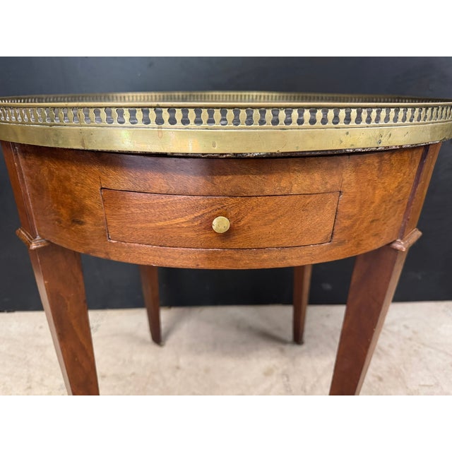 A good quality French round Louis XVI style Lamp Table. Having original grey marble top, 2 drawers and 2 slides. In...